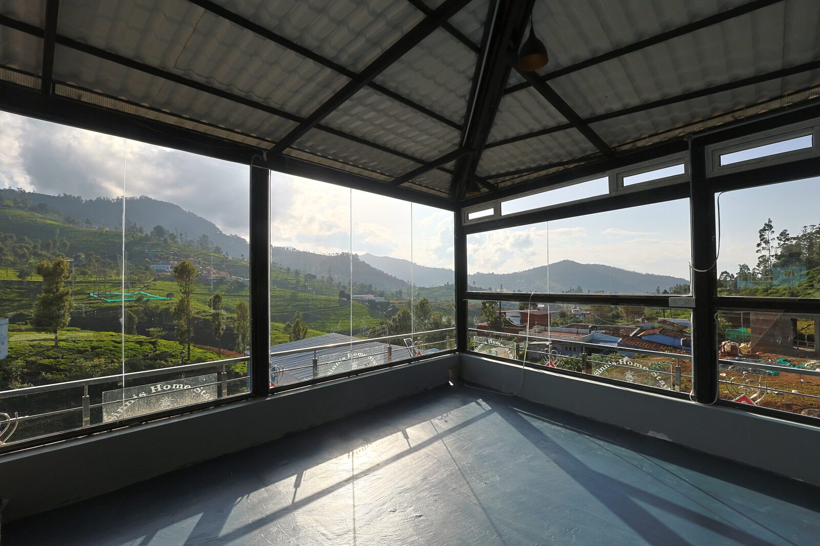 Corner of the banquet hall looking out over the Nilgiri hills through full-height glazing
