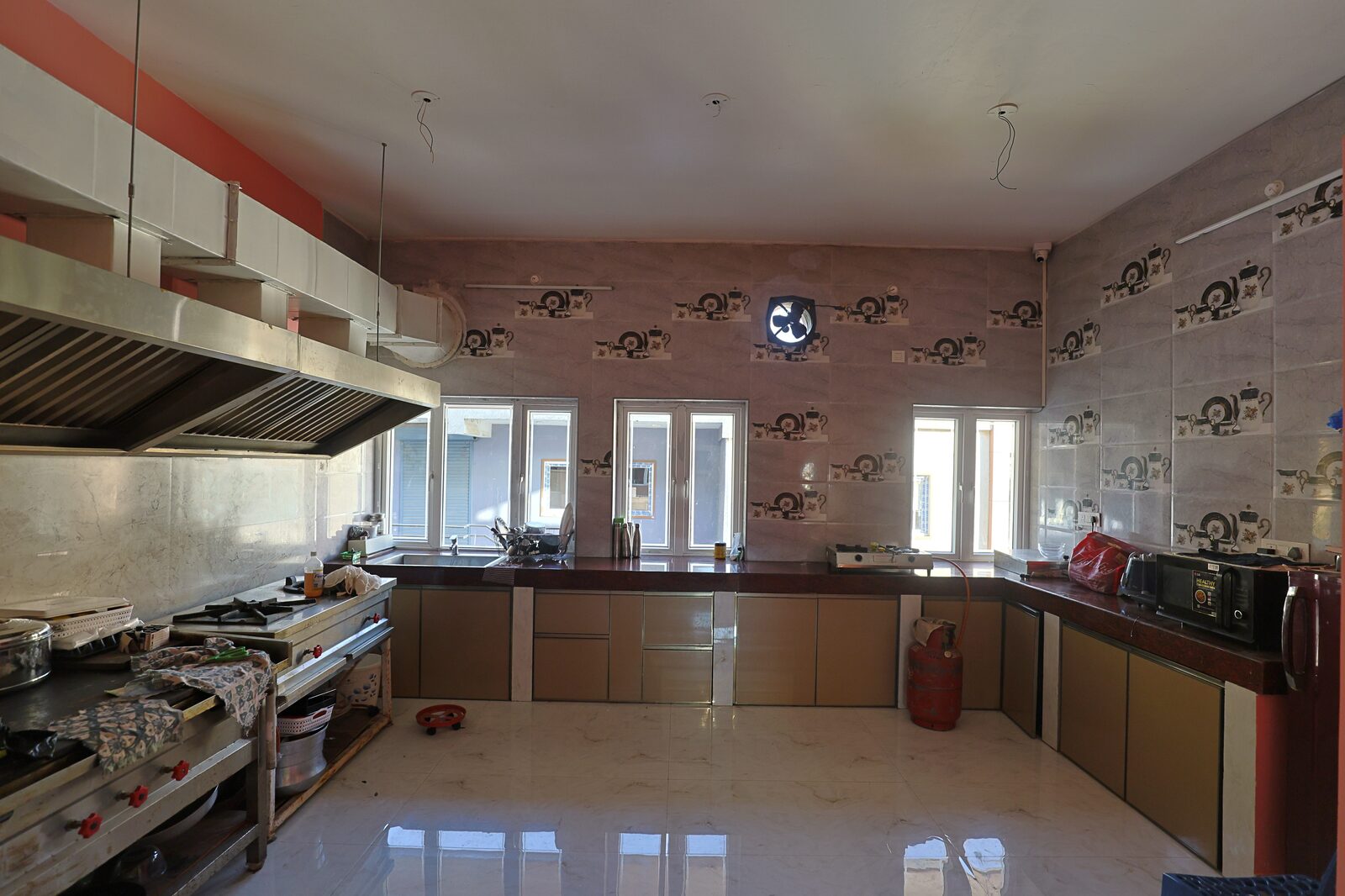 Commercial kitchen with stainless steel counters and extraction hoods