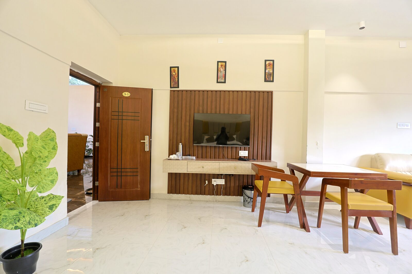 Guest room with its own dining table, entertainment wall and marble floor