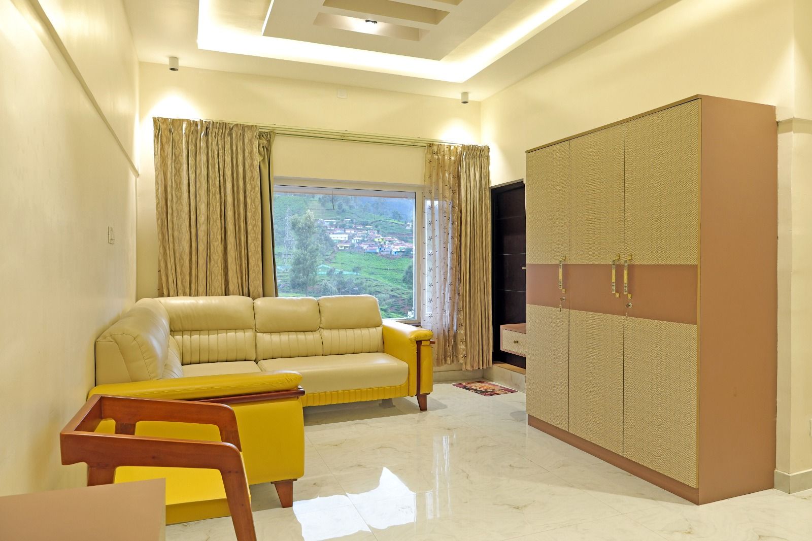 Living room with cream leather sofa and window view of the Nilgiri hills